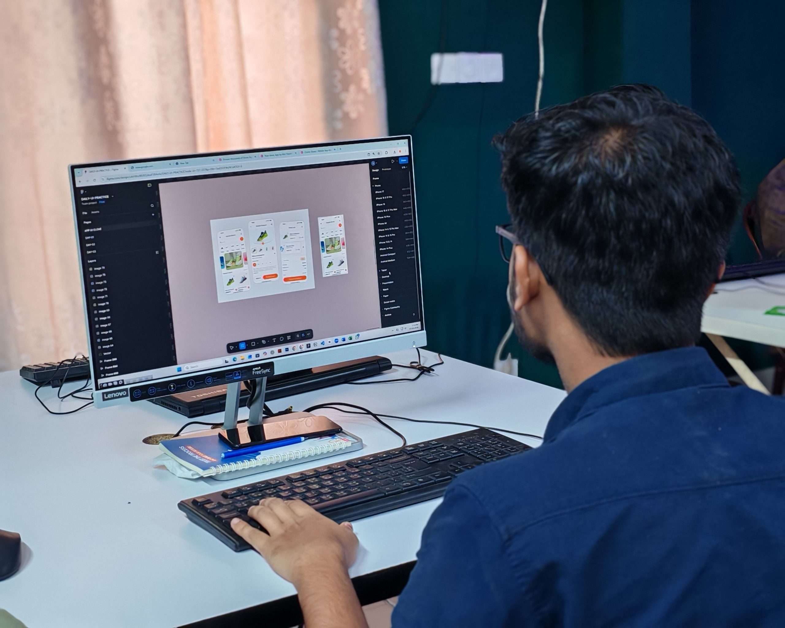 Designer creating UI on desktop computer