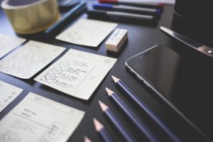 Creative workspace with UI design wireframe plans and sketches